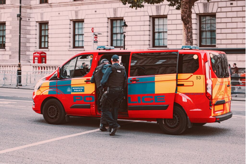 a couple of men standing next to a van